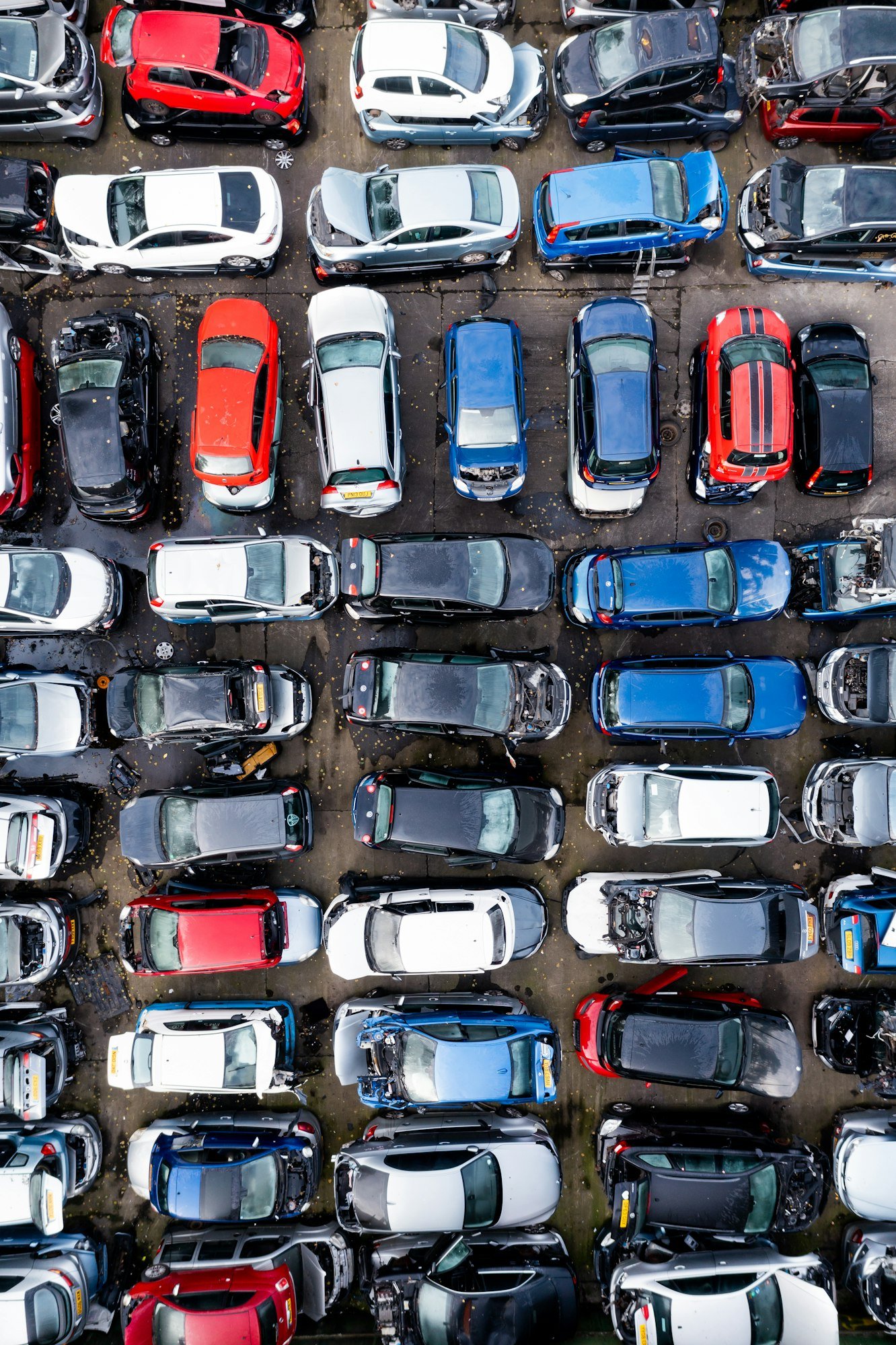 Full frame aerial view directly above rows of scrap metal cars